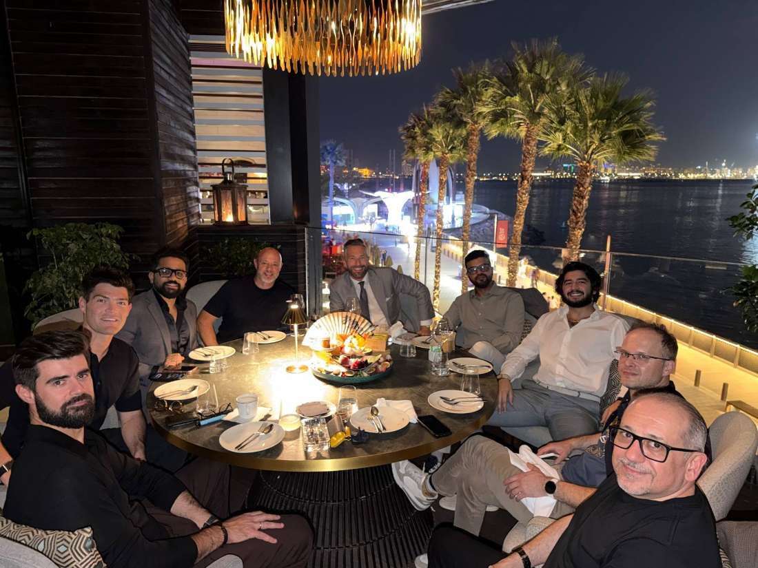 Investors at a dinner on a rooftop